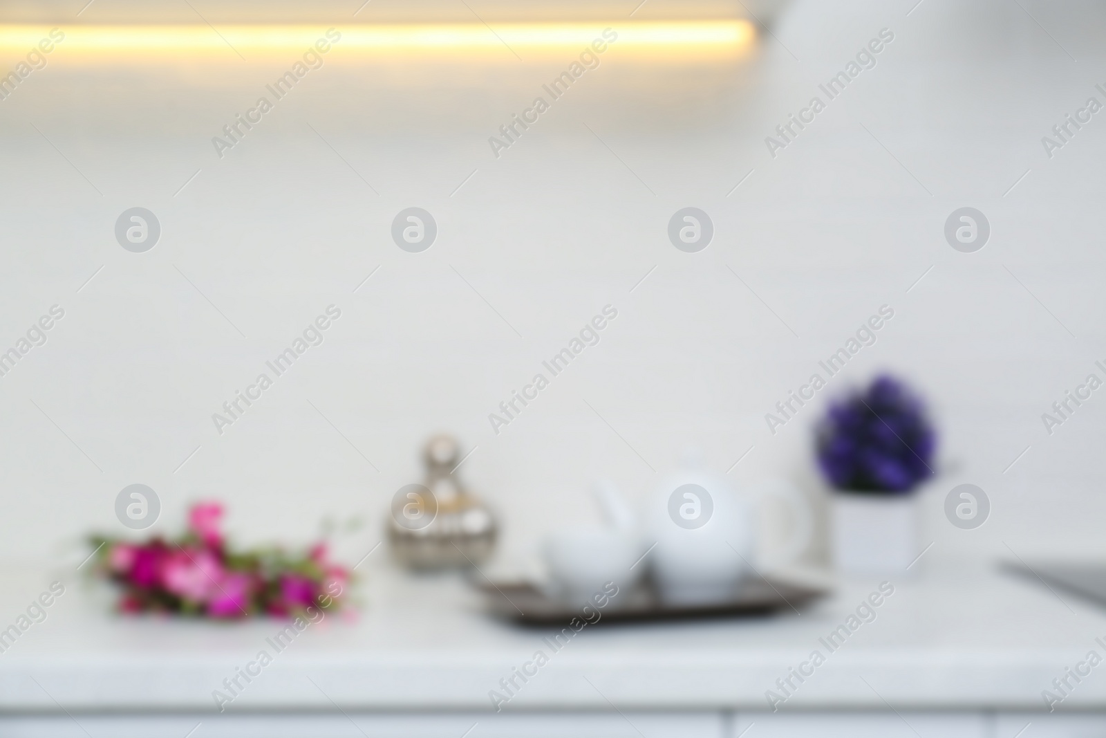 Photo of Blurred view of modern kitchen with white wall