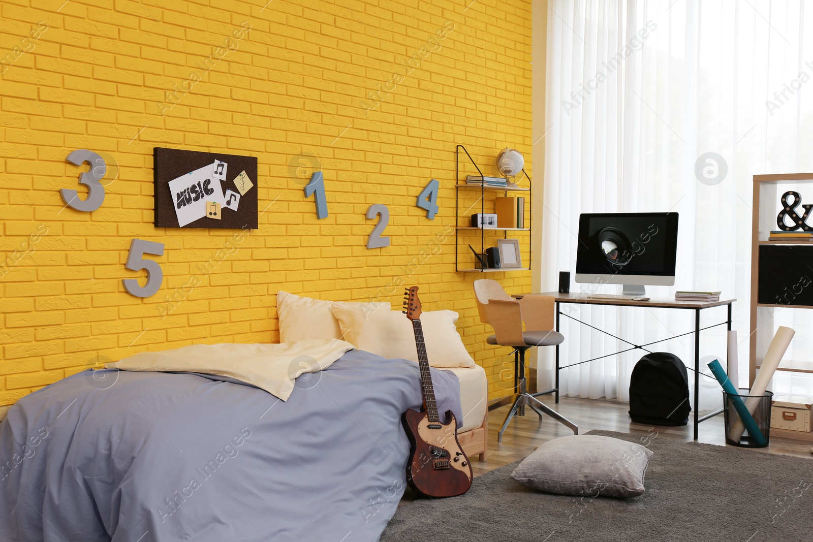 Photo of Stylish teenager's room interior with computer and bed