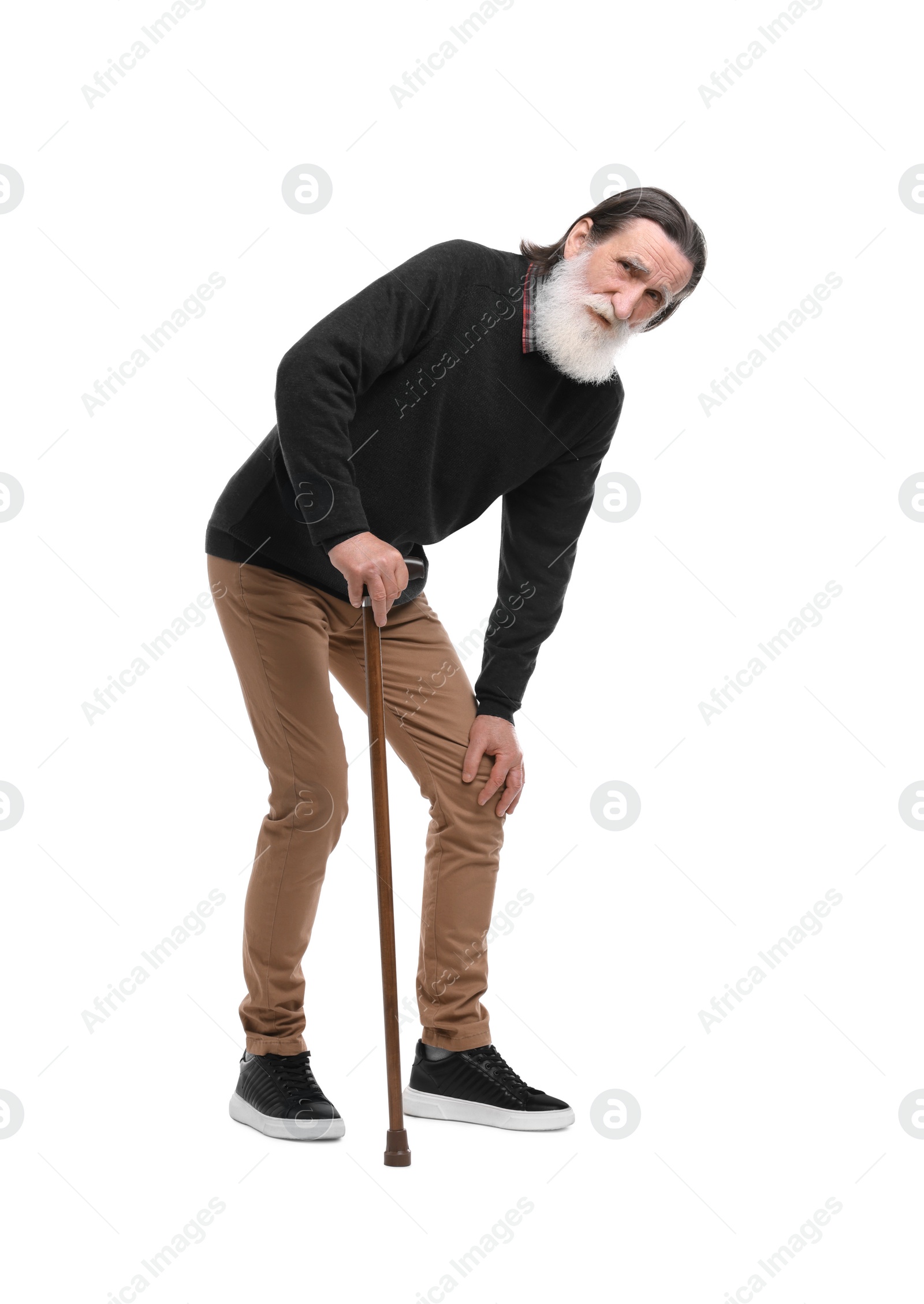 Photo of Senior man with walking cane suffering from knee pain on white background