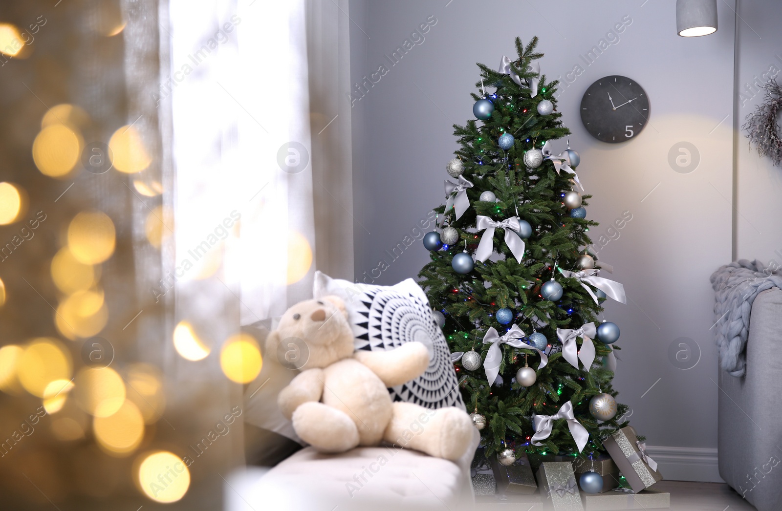 Photo of Room interior with beautiful Christmas tree and gifts