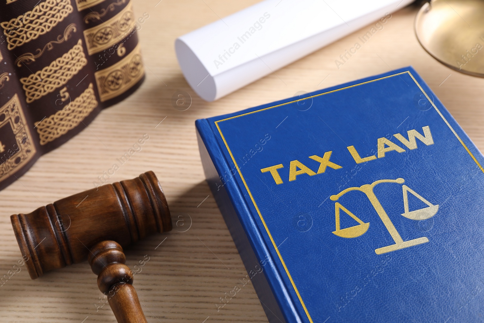 Image of Tax law book and gavel on wooden table