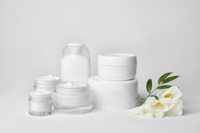 Composition with cosmetic products on light background