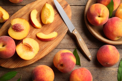 Flat lay composition with fresh sweet peaches on wooden table