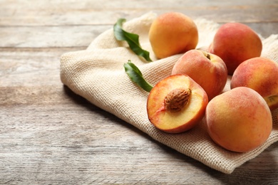 Photo of Fresh sweet peaches on wooden table. Natural fruit