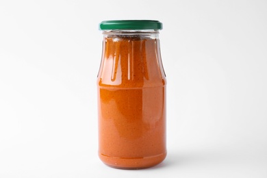 Jar of butternut squash spread on white background. Pickled food