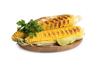 Photo of Delicious grilled corn cobs with parsley and lime on white background