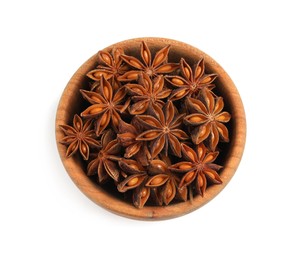 Photo of Wooden bowl with dry anise stars on white background, top view