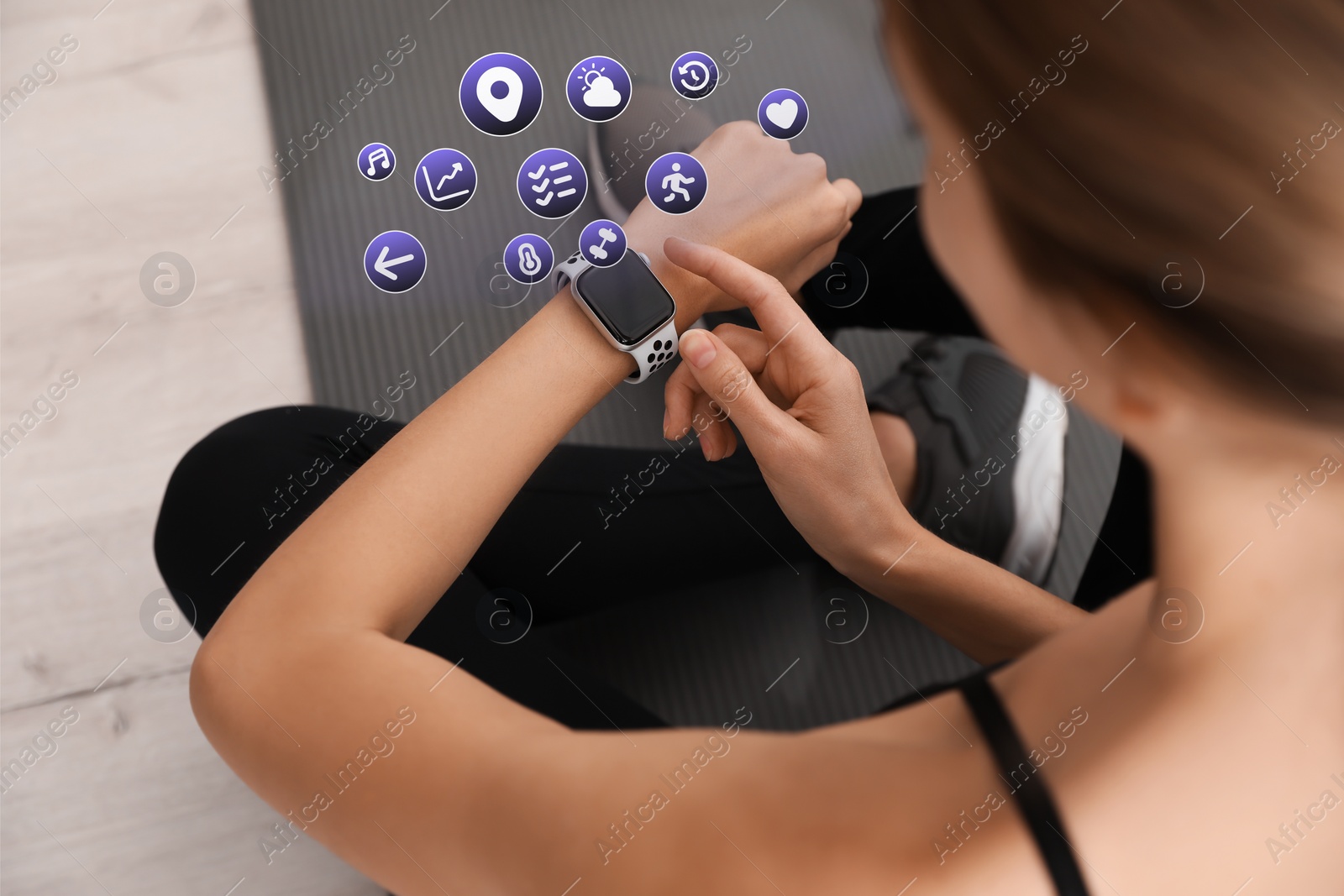 Image of Young woman using fitness tracker during training indoors, closeup