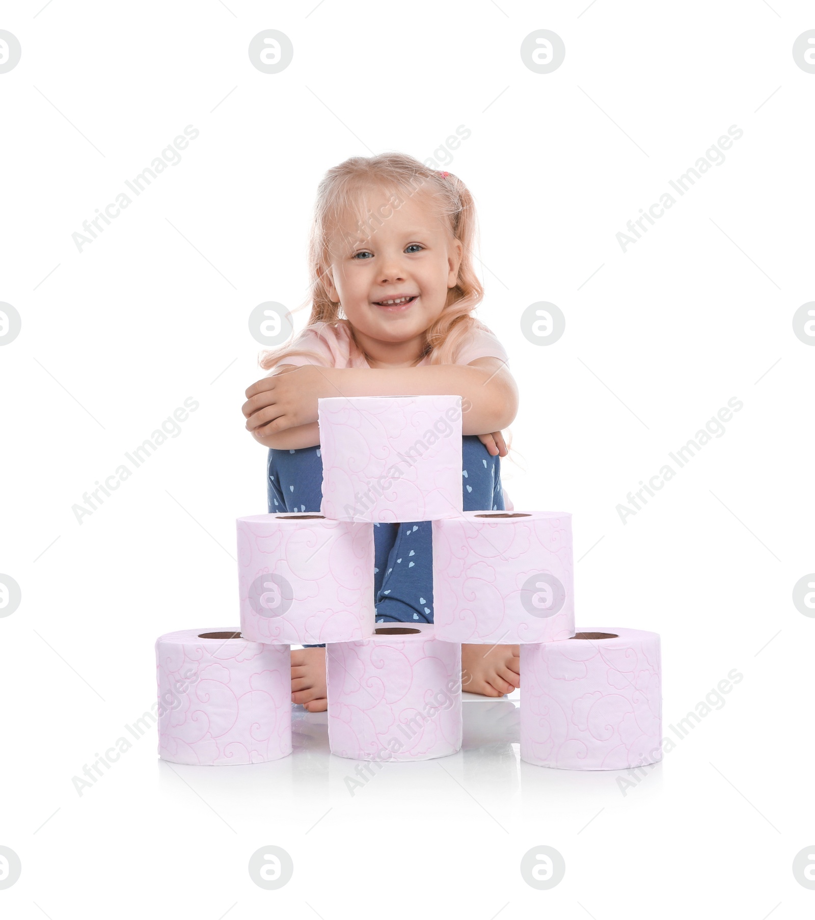 Photo of Cute little girl with toilet paper pyramid on white background