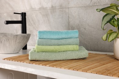 Photo of Stack of clean towels on countertop in laundry room