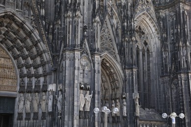 Cologne, Germany - August 28, 2022: Entrance of beautiful gothic cathedral outdoors
