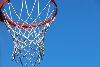 Basketball hoop with net outdoors on sunny day, space for text