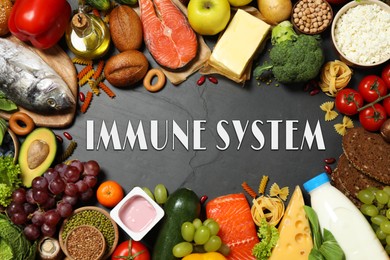 Image of Immune system boosting with proper nutrition. Different foods on black table, flat lay