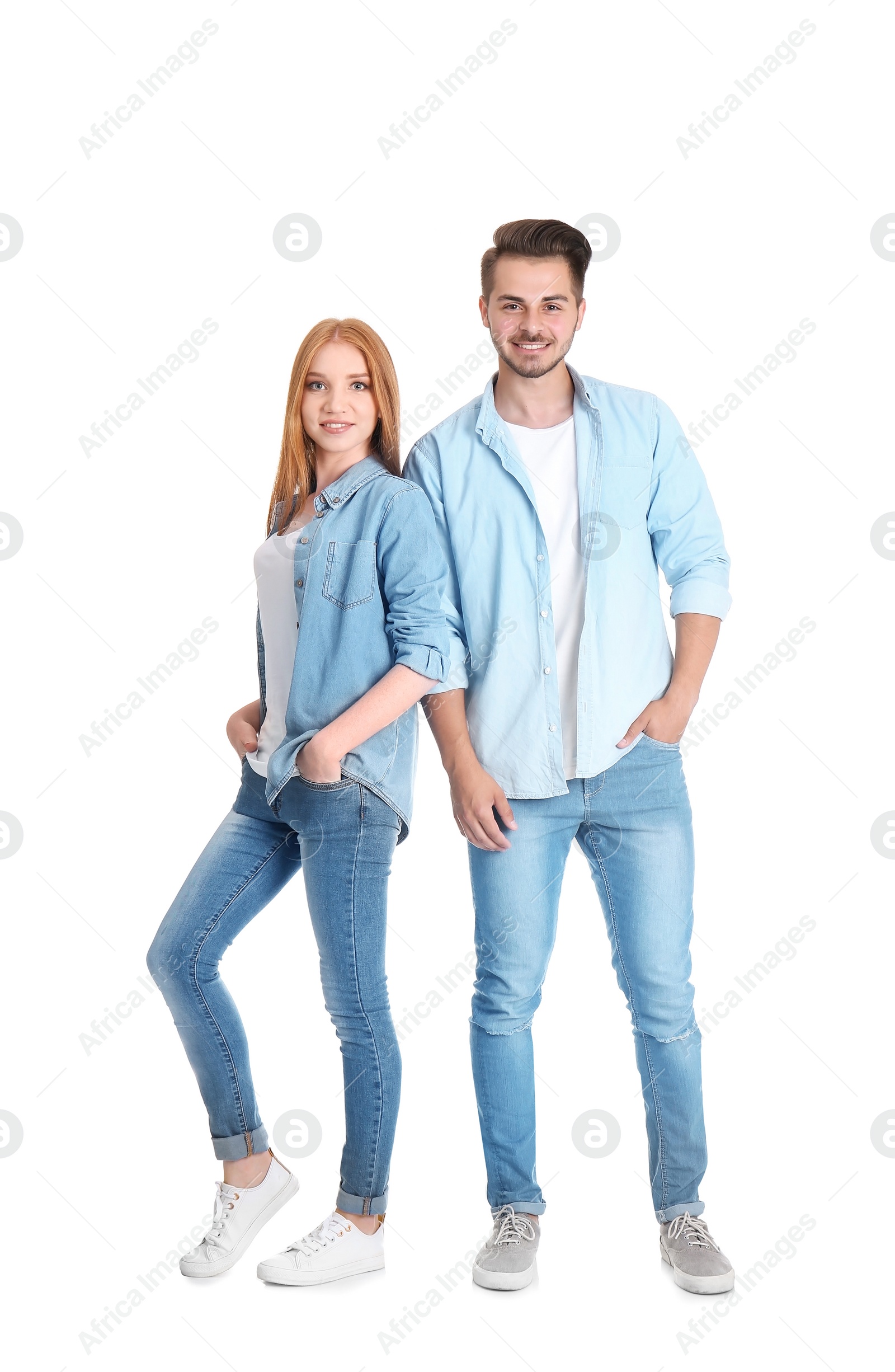 Photo of Young couple in stylish jeans on white background