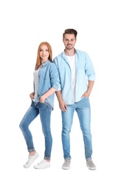 Young couple in stylish jeans on white background