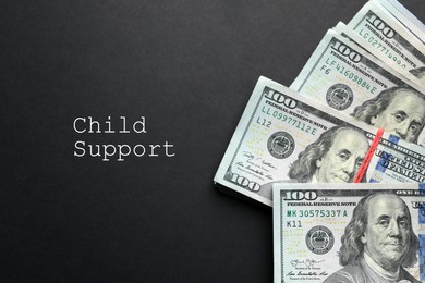 Image of Child support concept. Many dollar banknotes on black background, flat lay