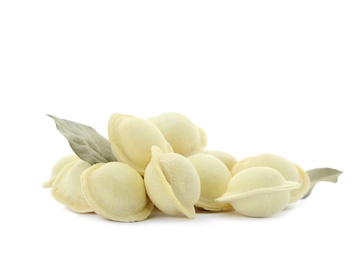 Photo of Raw meat dumplings with bay leaves on white background