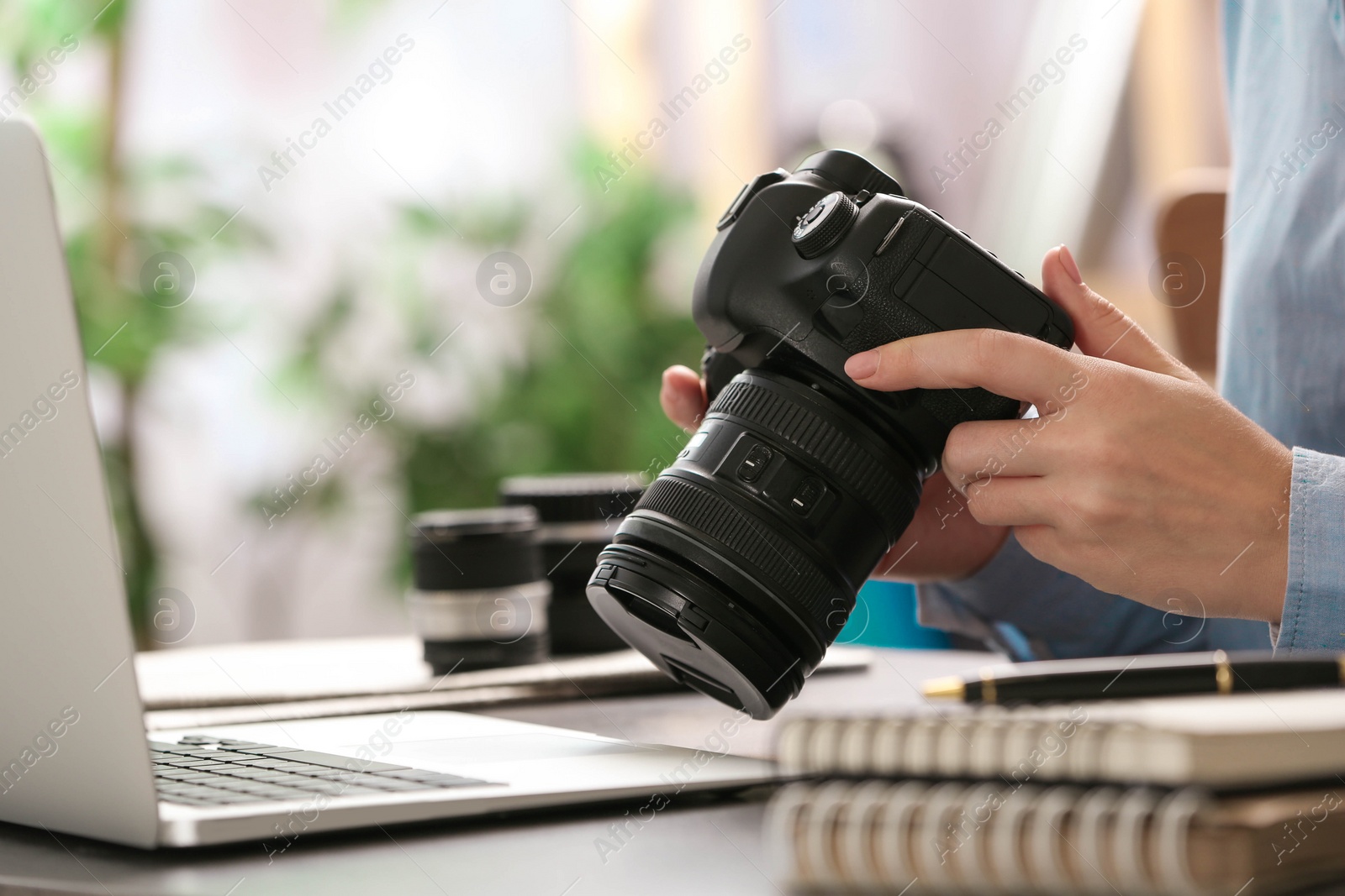 Photo of Journalist with camera working at table, closeup