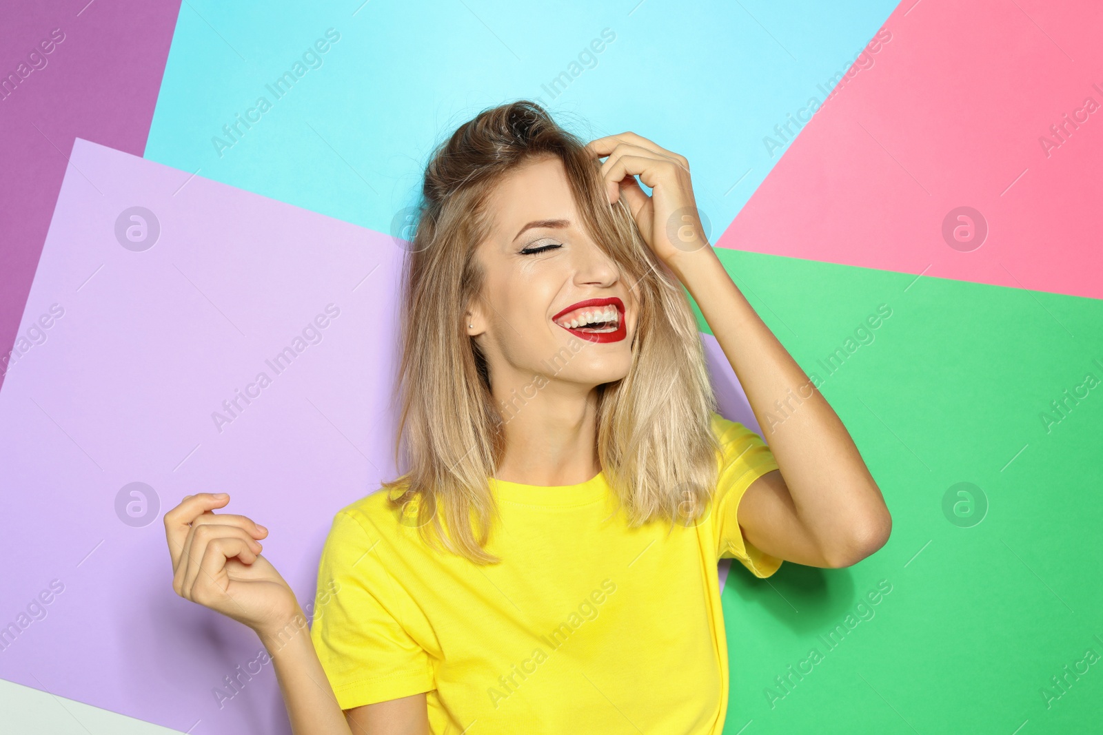 Photo of Beautiful young woman with healthy long blonde hair on color background