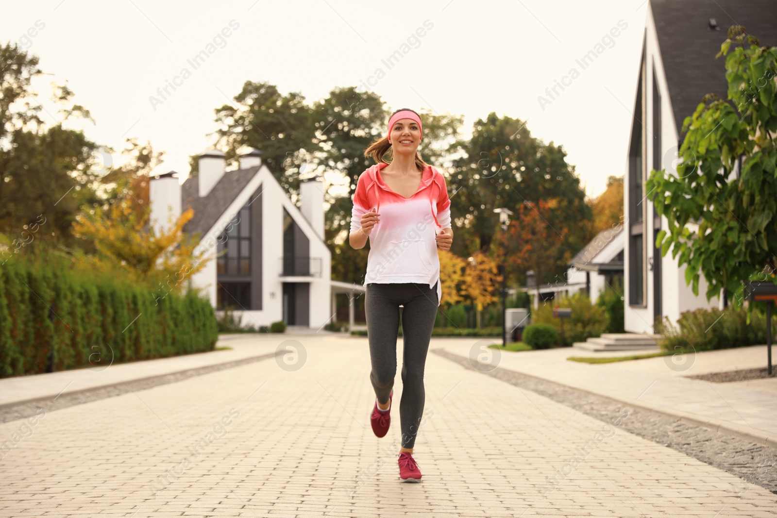 Photo of Beautiful sporty woman running on street. Healthy lifestyle