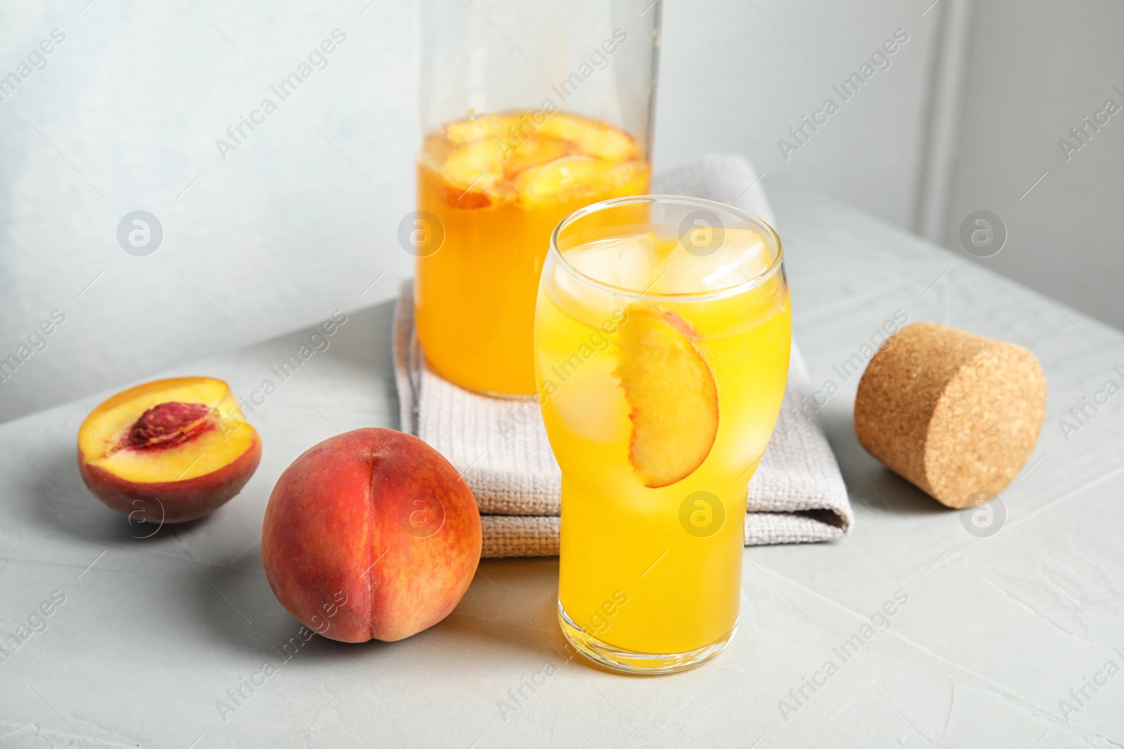 Photo of Tasty peach cocktail on table. Refreshing drink