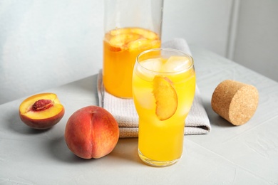 Photo of Tasty peach cocktail on table. Refreshing drink