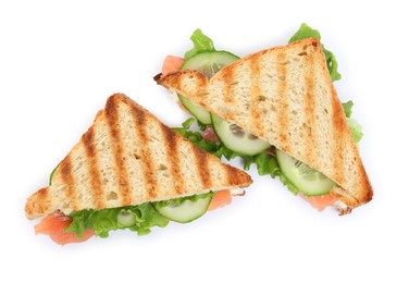 Tasty sandwiches with salmon and cucumber on white background, top view