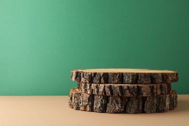 Photo of Presentation for product. Wooden stumps on color background. Space for text