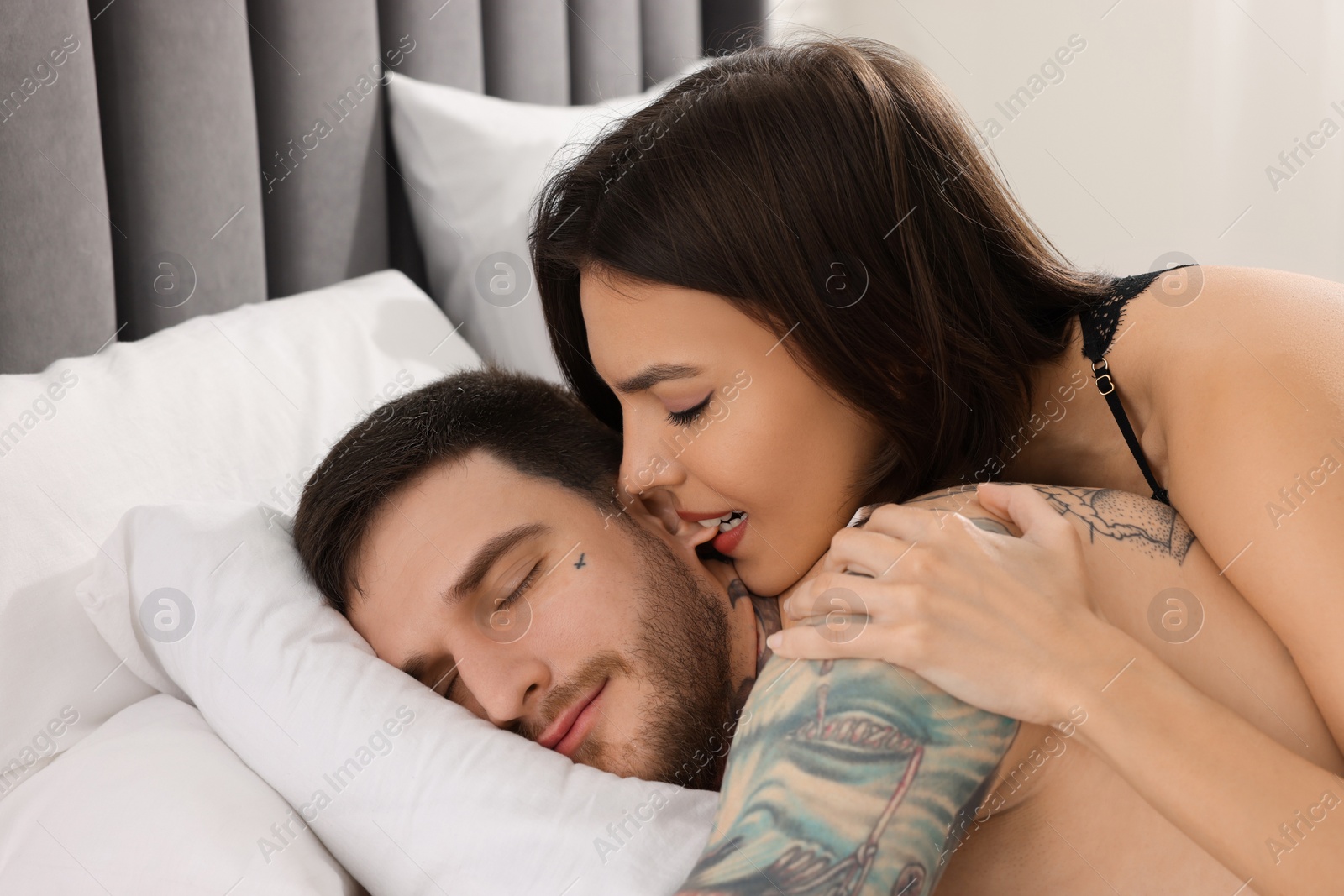 Photo of Passionate young couple having sex on bed