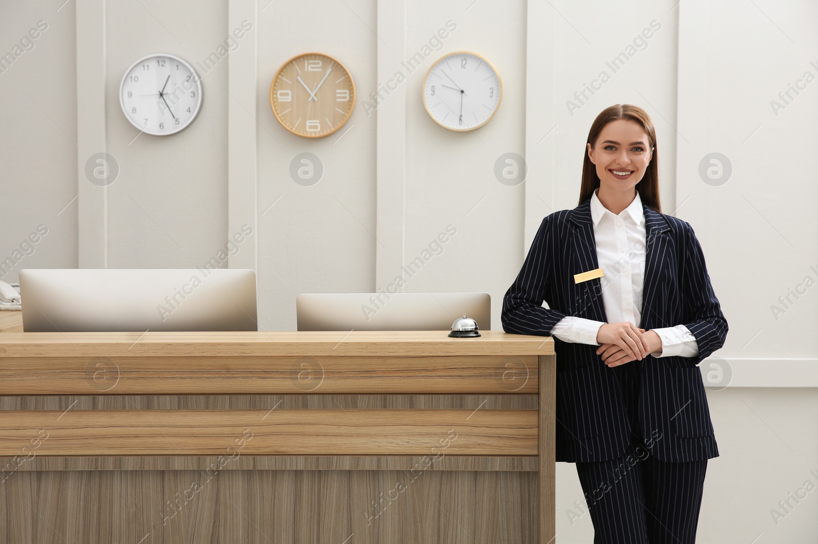 Photo of Portrait of beautiful receptionist near counter in hotel