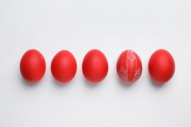 Photo of Composition of painted red Easter eggs on white background, top view