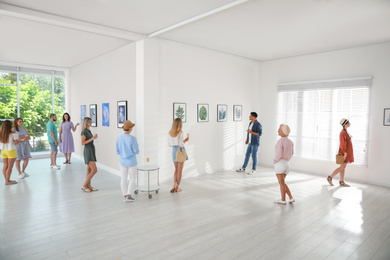 Group of people at exhibition in art gallery