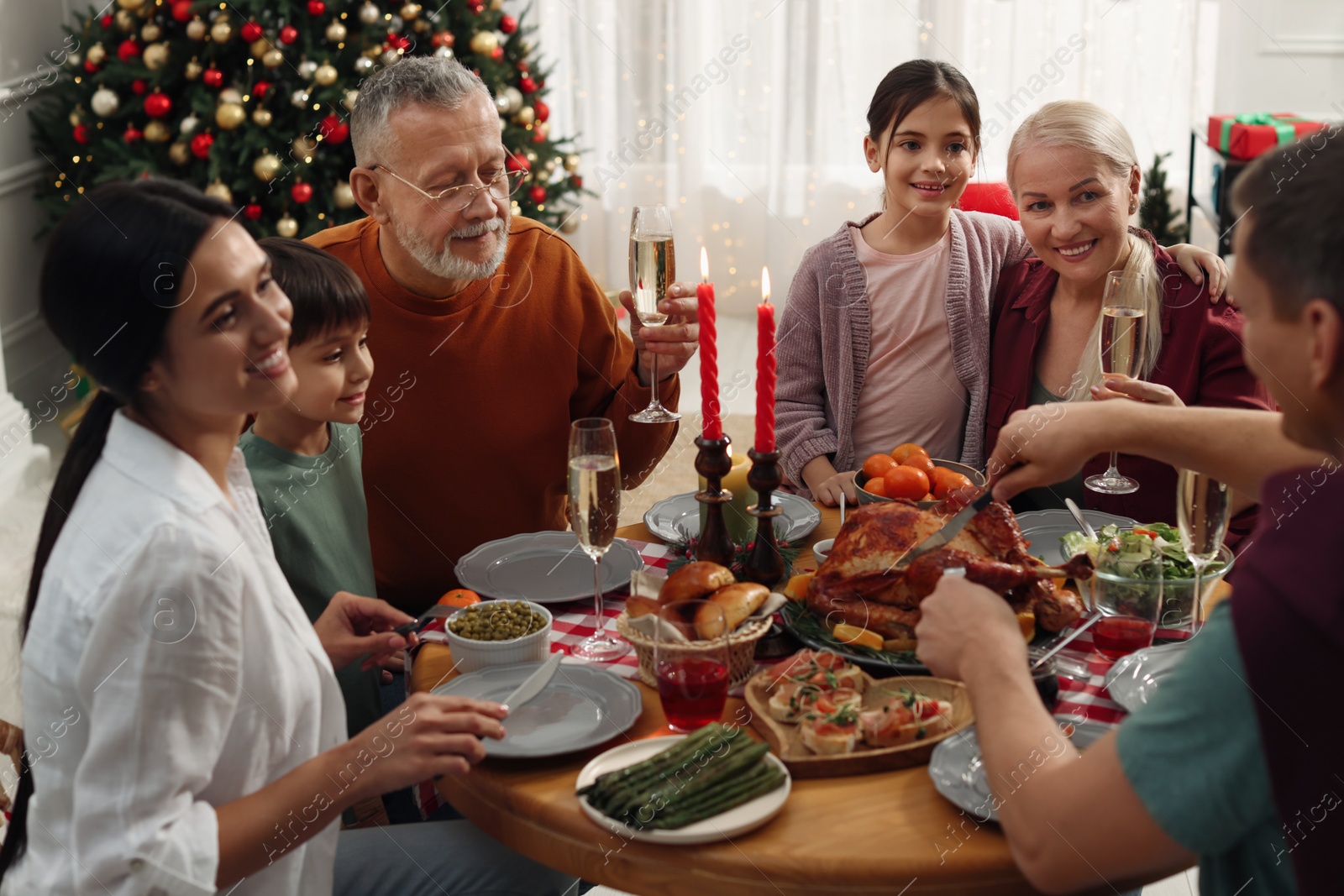 Photo of Happy family enjoying festive dinner at home. Christmas celebration