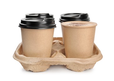 Photo of Takeaway paper coffee cups in cardboard holder on white background