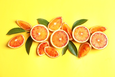 Fresh bloody oranges on color background, flat lay. Citrus fruits