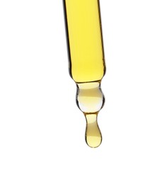 Photo of Dripping tincture from pipette isolated on white