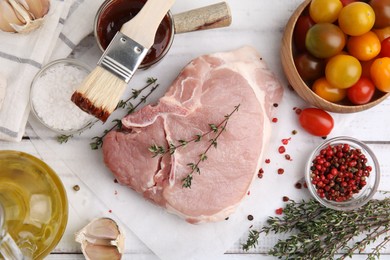 Flat lay composition with raw meat, thyme and marinade on white wooden table