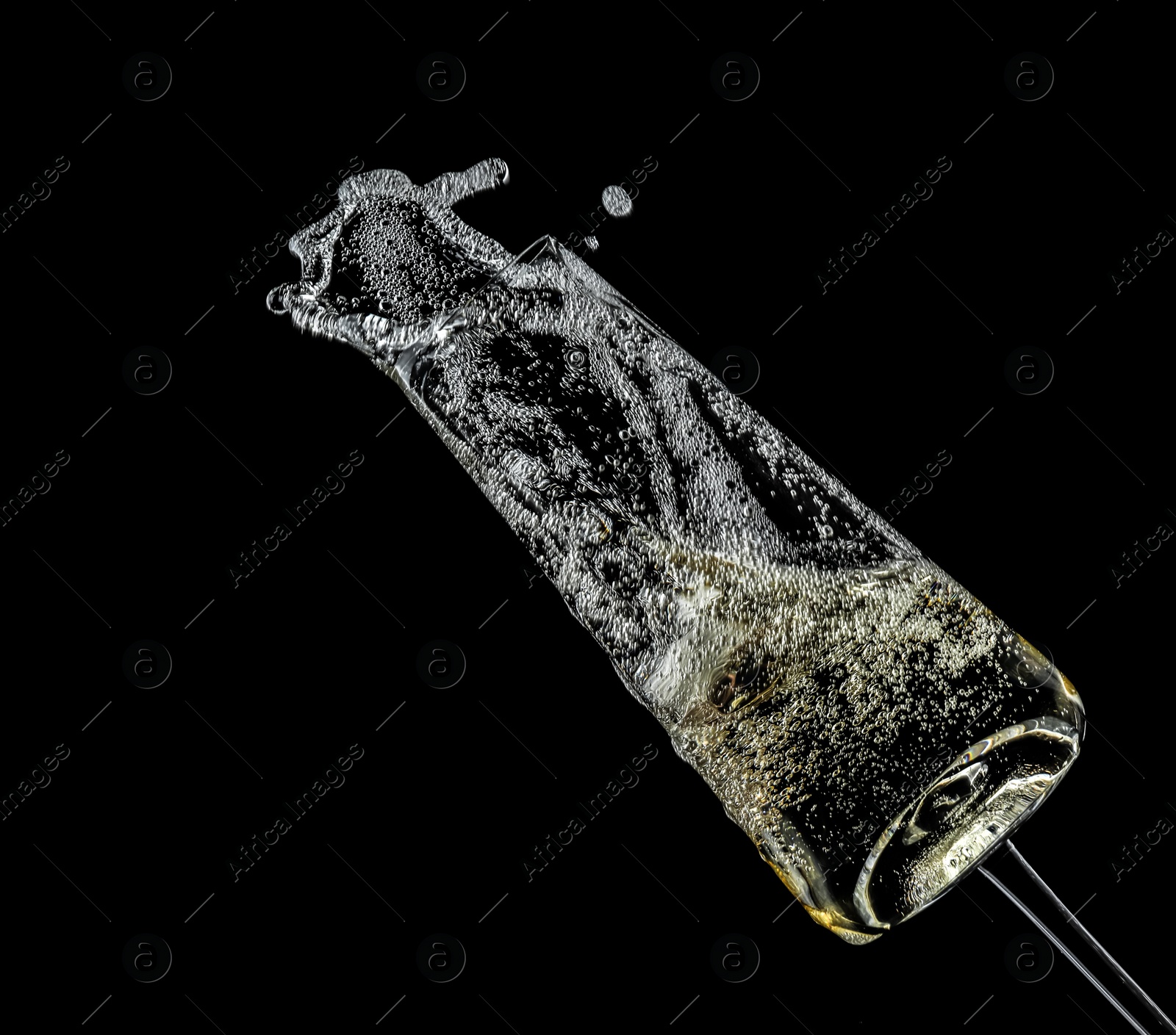 Photo of Glass of champagne on black background. Festive drink