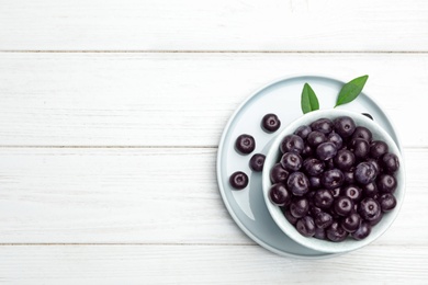 Photo of Flat lay composition with fresh acai berries on white wooden table, space for text