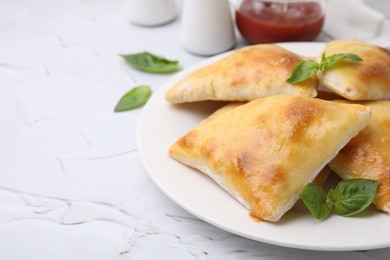 Delicious samosas and basil on white textured table, space for text