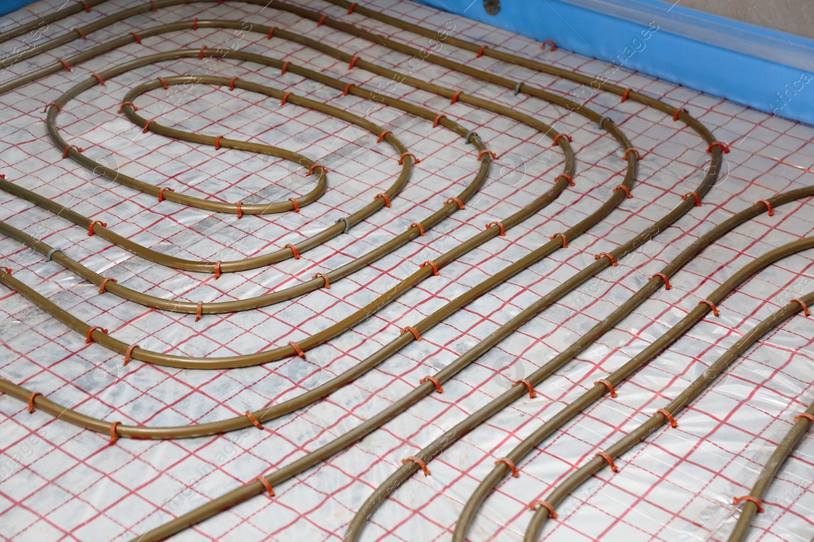 Photo of Installation of underfloor heating system in building