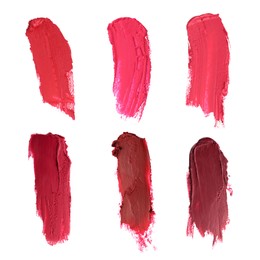 Image of Smears of different beautiful lipsticks on white background, top view