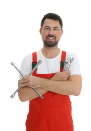 Photo of Portrait of professional auto mechanic with wrenches on white background