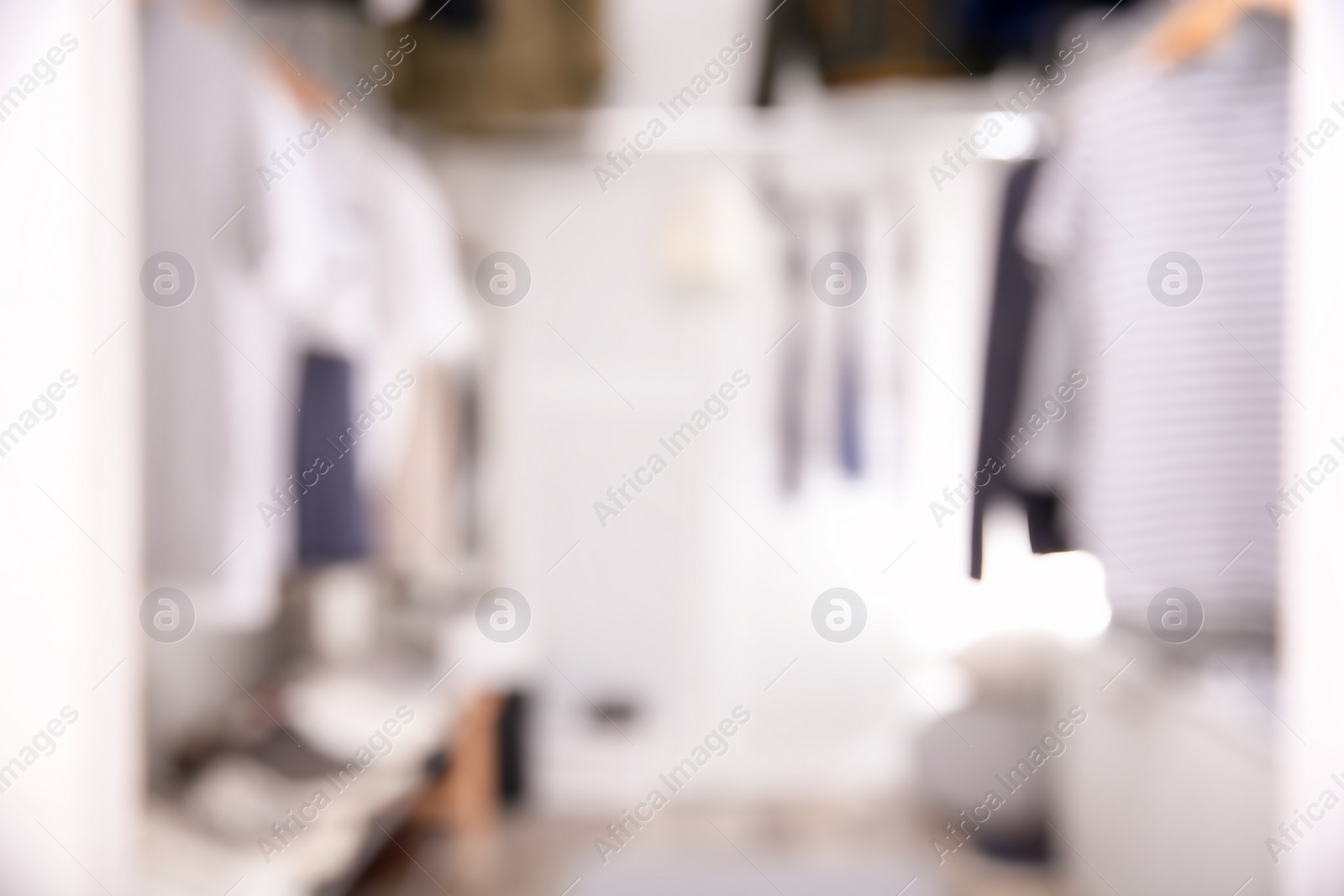 Photo of Blurred view of modern dressing room with stylish clothes