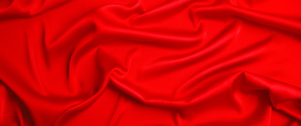 Red silk fabric as background, top view. Banner design