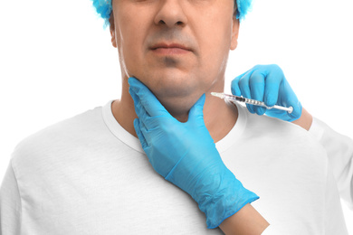 Photo of Mature man with double chin receiving injection on white background, closeup