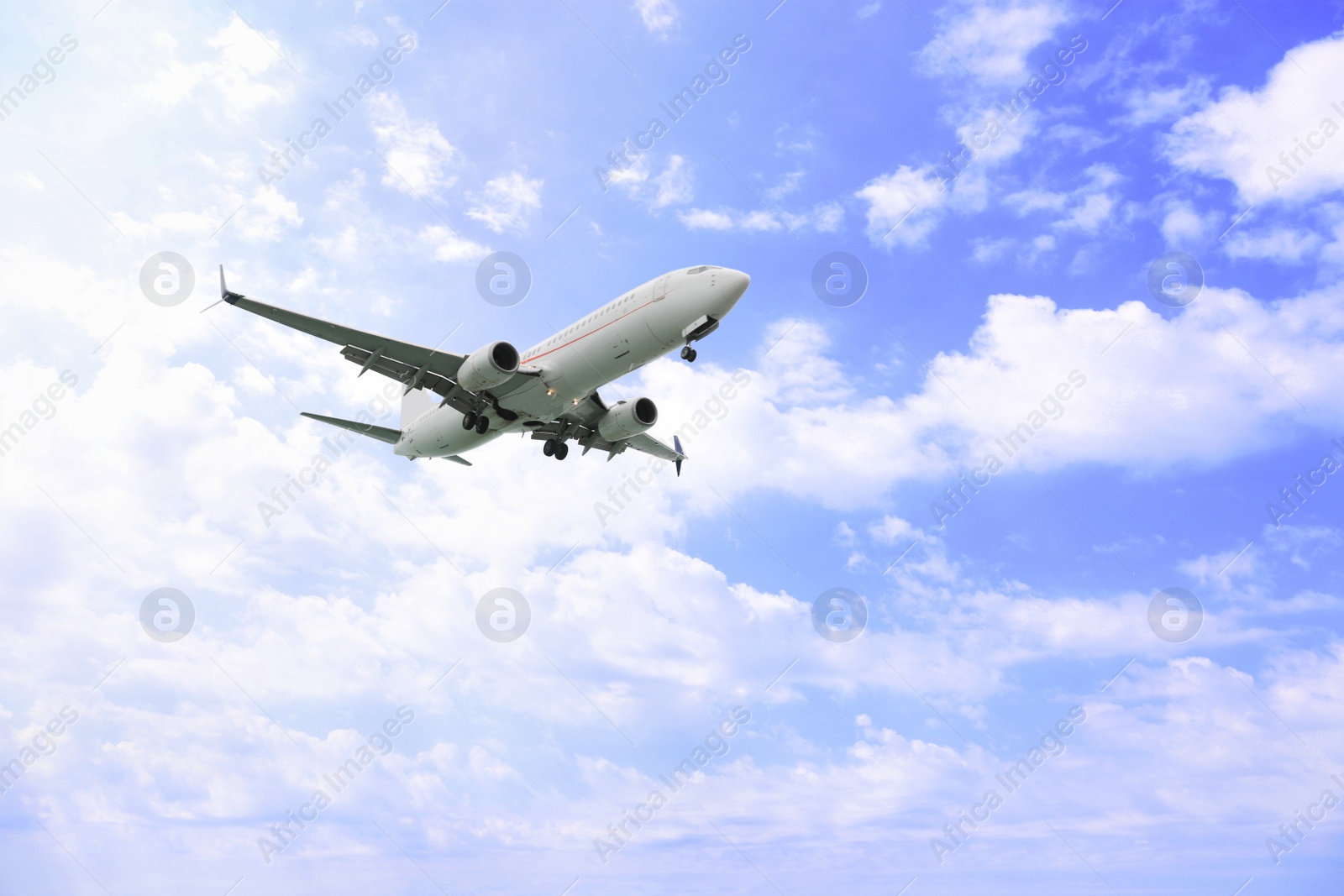 Photo of Airplane flying high in blue sky. Modern aircraft