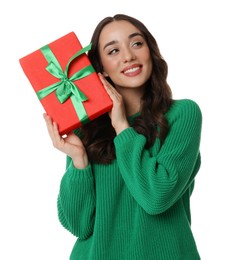 Beautiful young woman with Christmas gift isolated on white