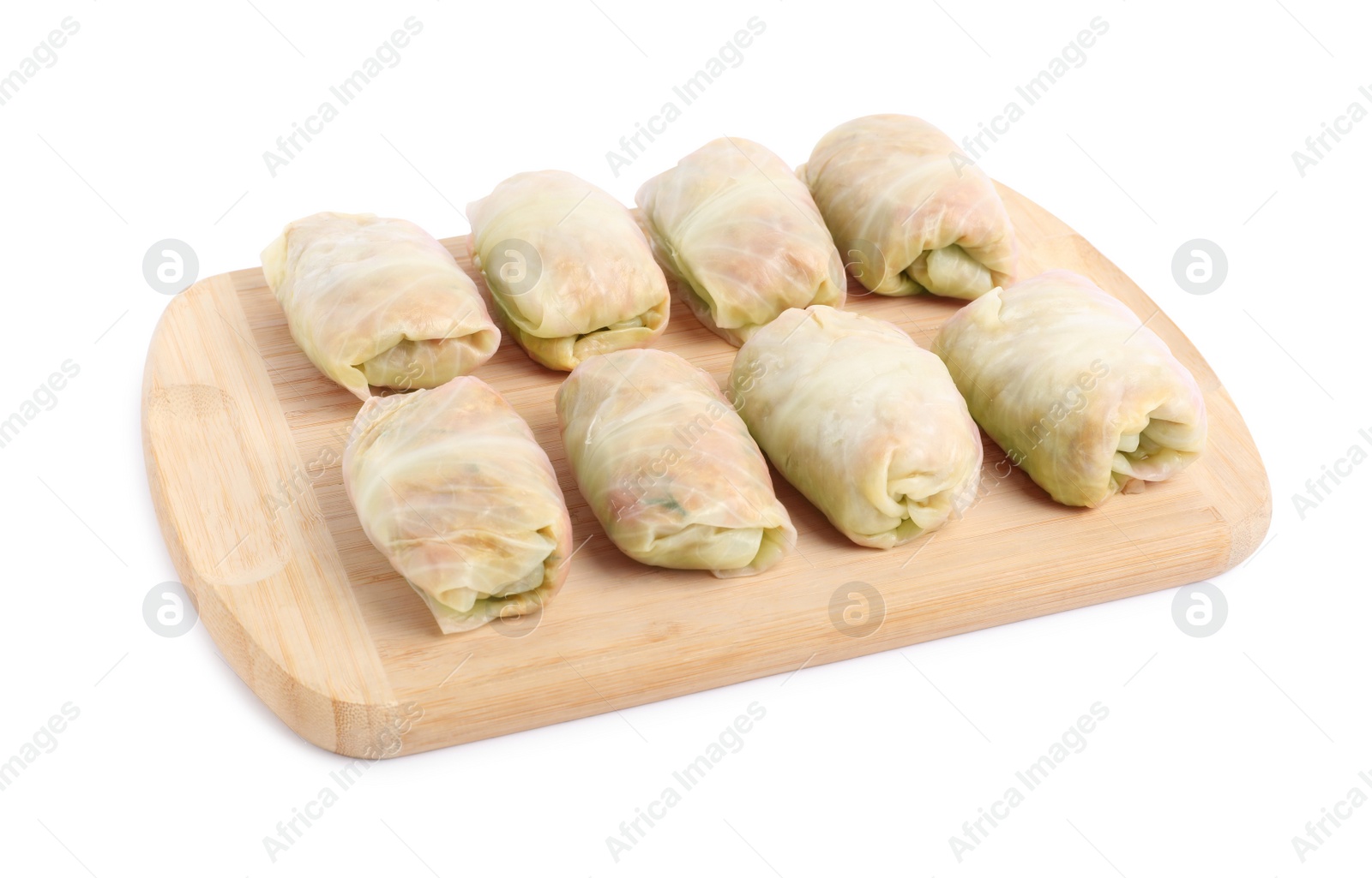 Photo of Wooden board with uncooked stuffed cabbage rolls on white background