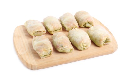 Wooden board with uncooked stuffed cabbage rolls on white background